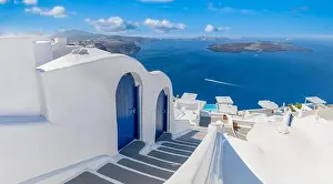 Beautiful travel background for vacation holiday banner. White houses in the town of Oia on the island of Santorini, panorama. Amazing scenic views