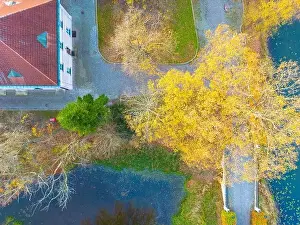 Foot Bridge Prints: Beautiful travel or tourism style look down aerial of pedestrian foot bridge across River at park with colorful fall