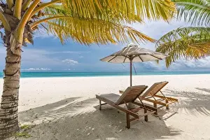 Beautiful tropical beach. White sand and coco palms chairs, umbrella travel tourism, amazing beach landscape. Luxury island resort vacation or holiday