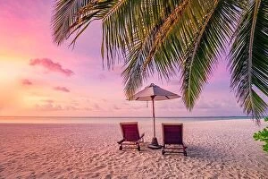 Images Dated 1st February 2022: Beautiful tropical island, couple chairs umbrella under palm tree leaves, paradise sea sand sky