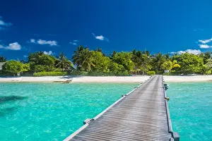 Beautiful tropical Maldives island with beach, sea, and coconut palm tree on blue sky for nature holiday vacation background concept, Boost up color