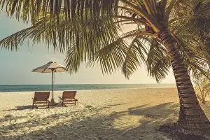 Beautiful tropical outdoor beach sea ocean with umbrella and chair. Landscape close to sea at sunset sunrise time for exotic summer travel vacation