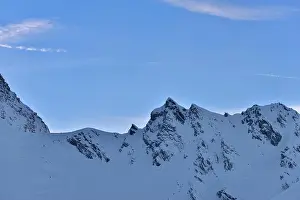 Peak Range Prints: Beautiful view of mountain peak with sunset light on top against clear blue sky