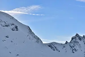 Beautiful view of mountain peak with sunset light on top against clear blue sky