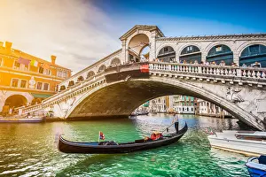Nostalgic Prints: Beautiful view of traditional Gondola on famous Canal Grande with Rialto Bridge at sunset in Venice