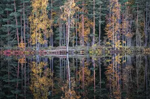 Beautiful water reflection view with fall colors and lake at autumn day in Finland