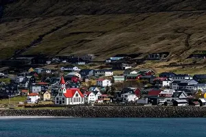 Travel Brochure Prints: A beautiful white and red church in a small village in Faroe Islands