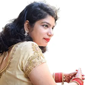 Applying Prints: Beautiful woman dressed up as Indian tradition with henna mehndi design on her both hands to celebrate big festival of