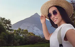 Sierra Prints: Beautiful woman in straw hat taking selfie in mountains