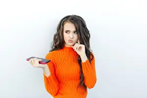 Trouble Prints: Beautiful young girl with dark hair phone thinks about something on hell background in a bright jacket