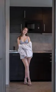 Waking Up Prints: Beautiful Young Girl is Standing in the Kitchen
