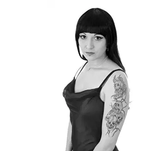 Punk Prints: Beautiful young woman showing her skull tattoo's on her upper arm while in an evening dress