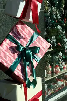 Gifts Prints: Beautifully wrapped presents hang outside a decorated store, spreading holiday joy
