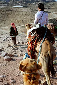 Alfresco Prints: Bedouin guide with tourist girl in a camel ride, Petra, Jordan