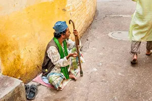 Passerby Prints: Beggar seeks alms on a narrow street in Nizamuddin, a Muslim suburb of Old Delhi, India