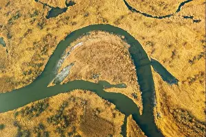 Belarus. Aerial View Of Dry Grass And Partly Frozen Curved River Landscape In Late Autumn Day. High Attitude View. Marsh Bog. Drone View. Bird's Eye V