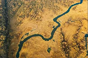Belarus. Aerial View Of Dry Grass And Partly Frozen Curved River Landscape In Late Autumn Day. High Attitude View. Marsh Bog. Drone View. Bird's Eye V