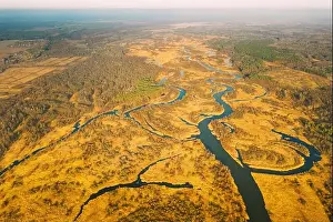 Belarus. Aerial View Of Dry Grass And Partly Frozen Curved River Landscape In Late Autumn Day. High Attitude View. Marsh Bog. Drone View. Bird's Eye V