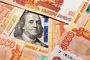Benjamin Prints: Benjamin Franklin on a hundred dollar bill surrounded by Russian rubles with a face value of five thousand each