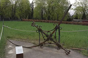 Bent Prints: Bent metal Tower Cross of the Reconciliation Church secured to concrete by grass expanse