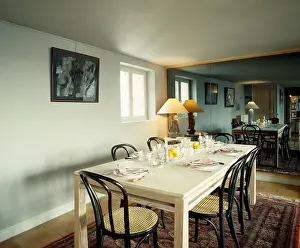 Rooms Prints: Bentwood chairs and simple pale wood table in dining room with mirrored wall