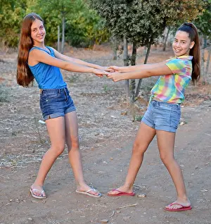 Sandals Prints: Best Friends Forever - two 12 year old teenage girls holding hands