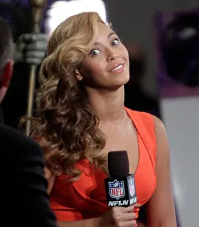 Super Bowl Prints: Beyonce Knowles is interviewed on the NFL Network at the Super Bowl Media Center on January 31