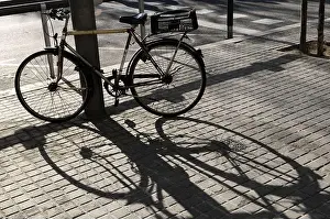 Cobbled Prints: Bicycle and its shadow in Barcelona, Catalonia, Spain