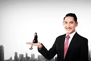 Employer Prints: Big boss holding asian business woman in his hand with smile