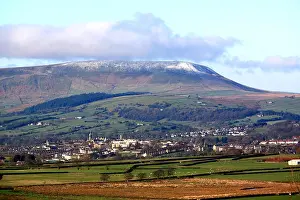 Pennines Prints: The 'Big End' of Pendle Hill with a dusting of snow looks down on the town of Colne