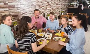 Siblings Prints: Big friendly family having fun and dinning in cafe
