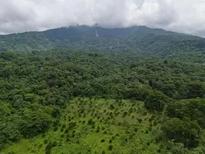 Environment Park Prints: Big green mountain volcano with white clouds aerial drone view