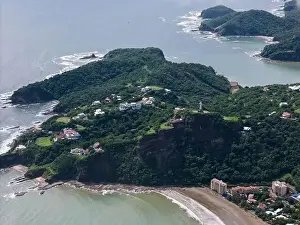 San Juan Prints: Big green rock with statue in San Juan Del Sur aerial drone view