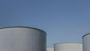 Space For Copy Prints: four big grey oil cisterns against the blue sky with space for copy