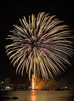 Blue Boat Prints: Big yellow firework on the sky at Pattaya coast with cityscape background, Thailand