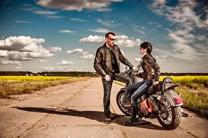 Motorcyclist Prints: Bikers couple stands on the road