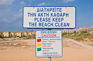Ayia Napa Prints: Bilingual PLEASE KEEP THE BEACH CLEAN sign on beach near Ayia Napa on the Mediterranean island of Cyprus EU