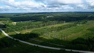 Emerging Prints: Bird's-eye view. Clip.Green forest around the river with plants around and pipes and white clouds around