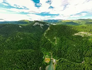 Shack Prints: Birds eye view of a lake in the mountains surrounded by a green pine forest