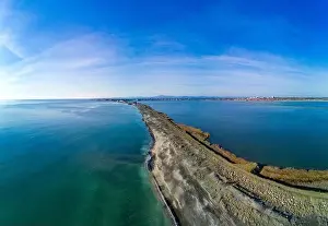Sea Island Prints: A bird's eye view panorama of a wild sandy dry grass shore washed by a deep calm evening Black sky in Bulgaria