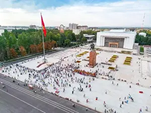 Kyrgyzstan Prints: Bishkek, Kyrgyzstan - July 15, 2023: Aerial view of Bishkek city's Ala-Too central square with waving flag