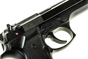 Semi Prints: detail of a black 9mm pistol isolated over a white background