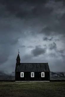 Chapel Prints: The Black Budir Church at Snaefellsnes Peninsula with a stormy cloudy sky in Iceland