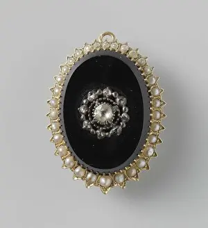 Sparkling Prints: A black git brooch. The oval brooch is surrounded by a golden border with pearls