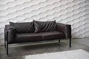 Comfy Prints: Black leather sofa on a white background in studio