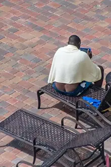 Beautiful Day Prints: Black man exposing his butt crack while sitting on lounge chair