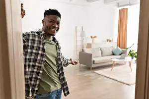 Rental Prints: Black Man Opening Door Gesturing Inviting To Come In Indoor