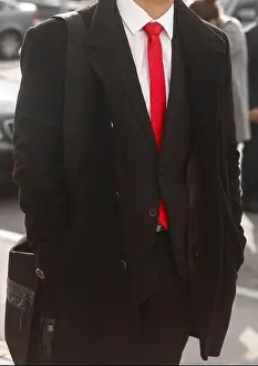 Tuxedo Prints: Black men's coat and suit with white shirt and red tie close-up