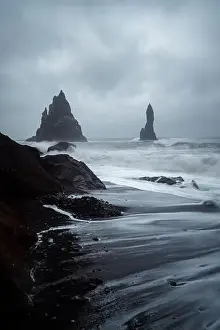 Black Sand Beach in Iceland. White waves crash onto the inky Icelandic shore