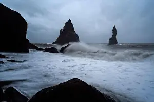 Black Sand Beach in Iceland. White waves crash onto the inky Icelandic shore